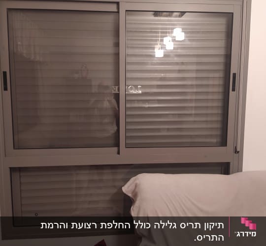 תריסים אפורים סגורים בחלון זכוכית כפול
